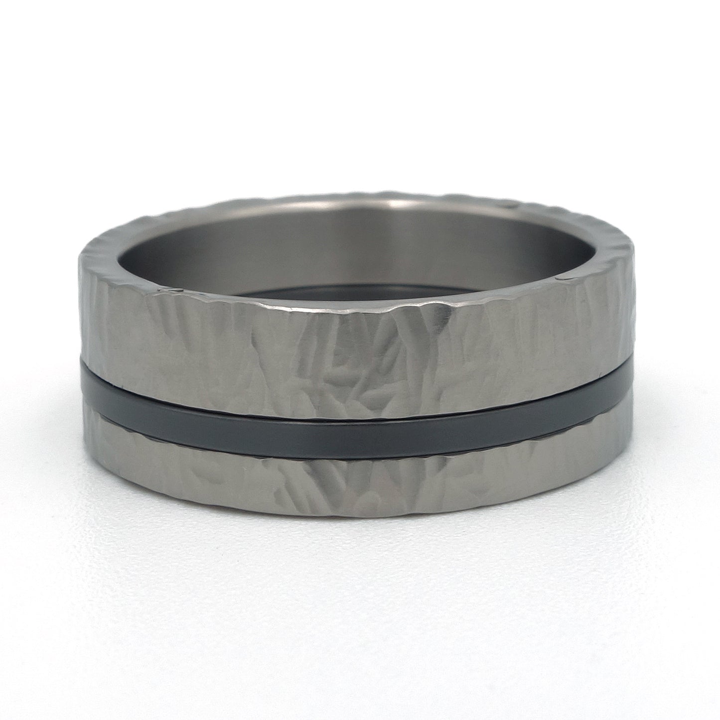 Titanium ring met zwarte zirkonium lijn en hamerslagstructuur, driedelige constructie met witgouden klinknagels