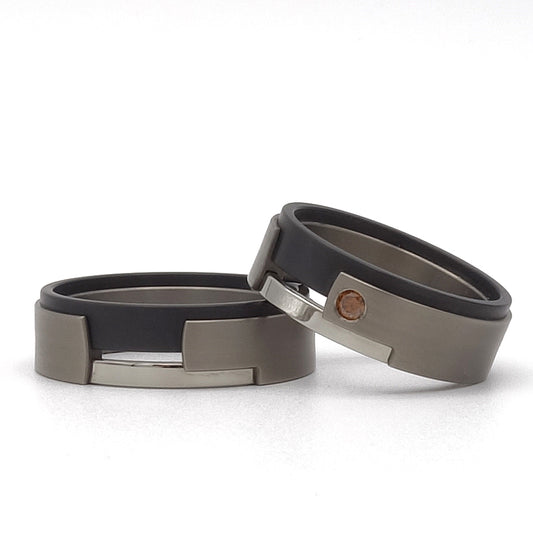 Aquila set in titanium, zirkonium en edelstaal – damesring met rode cherry diamant in modern contrastontwerp.

