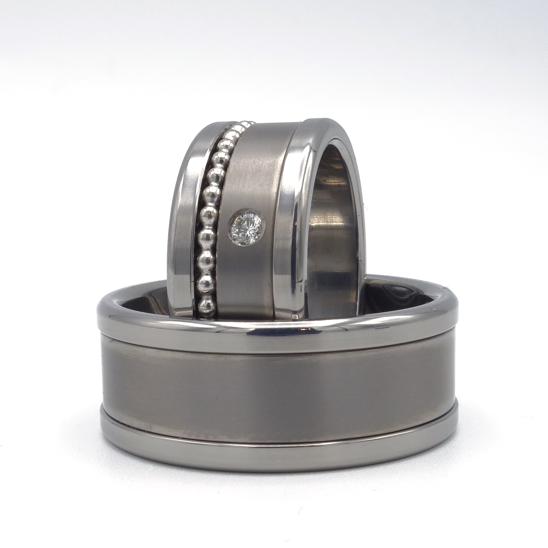 Dante ringenset – moderne trouwringen met geometrisch lijnenspel en diamantaccent in de damesring.

